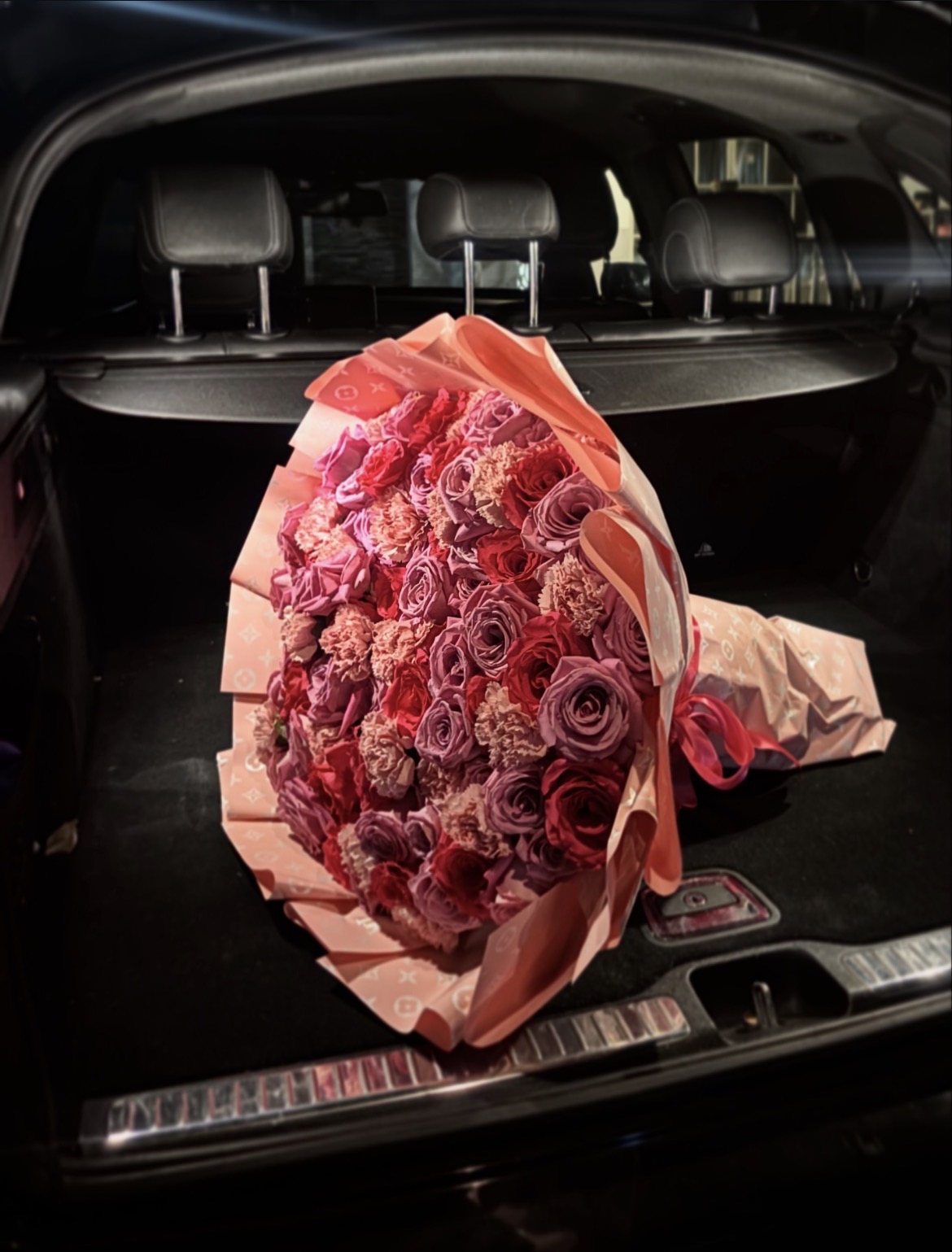 Signature 5star.fleur luxury bouquet with pink roses, orange ranunculus and white peonies wrapped in black paper